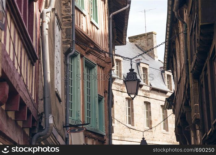 beautiful streets of the old famous city of Dinan in Normandy, France. street lamp in the foreground.