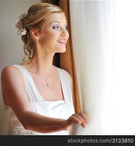 beautiful stylish bride in white dress in room