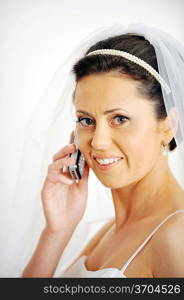 beautiful stylish bride speaks on phone. Studio portrait