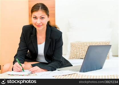 beautiful successful woman working at the hotel beds