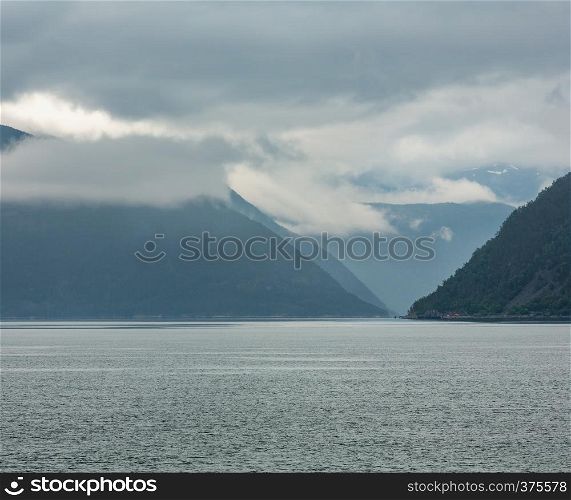 Beautiful summer cloudy evening fjord view, Norway.