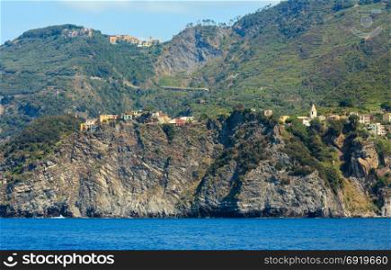 Beautiful summer Corniglia view from excursion ship. One of five famous villages of Cinque Terre National Park in Liguria, Italy, suspended between Ligurian sea and land on sheer cliffs.