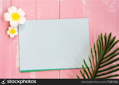 Beautiful summer holiday, Beach accessories, flower and palm leave on paper for copy space