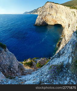 Beautiful summer Ionian Sea rocky coastline with flowers on hill (Lefkada, Greece)