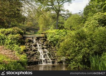 Beautiful Summer landscape image of stream flowing over rocks in waterfall in countryside