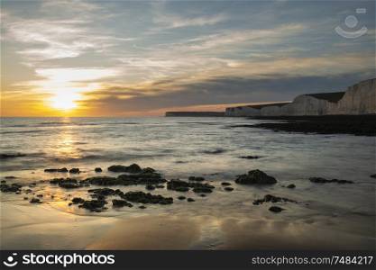 Beautiful Summer landscape sunset image of Seven Sisters chalk cliffs in England