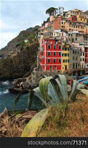 Beautiful summer Manarola - one of five famous villages of Cinque Terre National Park in Liguria, Italy, suspended between Ligurian sea and land on sheer cliffs. People unrecognizable.