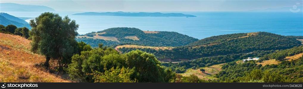 Beautiful summer seascape with a wooded coast, view from the Athos Peninsula, Sithonia and Amoliani island in mist in background  Halkidiki, Greece .