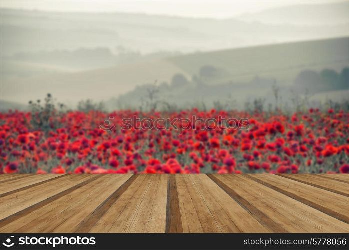 Beautiful Summer sunrise countryside field of poppies landscape with wooden planks floor