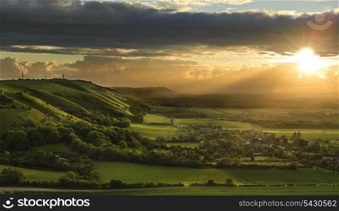 Beautiful Summer sunset over English countryside landscape