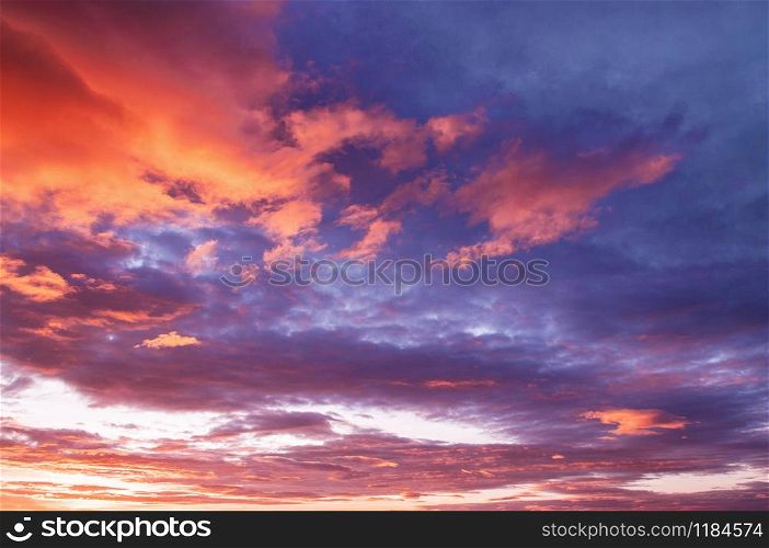 Beautiful summer two tones red vibrant burning sunset or sunrise sky with scattered clouds