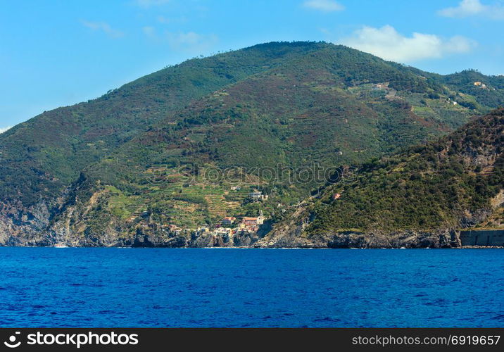 Beautiful summer Vernazza view from excursion ship. One of five famous villages of Cinque Terre National Park in Liguria, Italy, suspended between Ligurian sea and land on sheer cliffs.