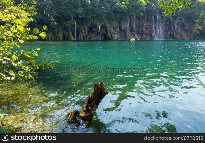 Beautiful summer waterfalls and green limpid lake in Plitvice Lakes National Park (Croatia)