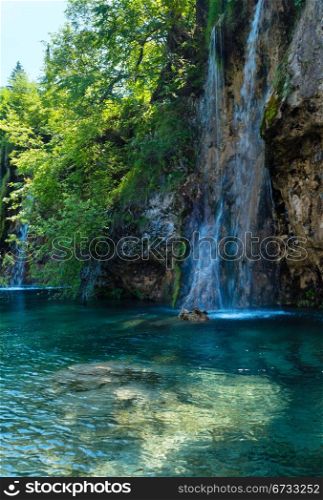 Beautiful summer waterfalls and limpid lake view in Plitvice Lakes National Park (Croatia)