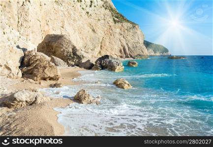 Beautiful summer white Porto Katsiki beach on Ionian Sea (Lefkada, Greece) and sunshine in blue sky