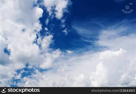 beautiful sun between clouds in a blue sky