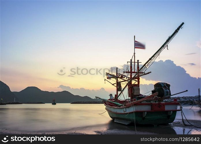 beautiful sun rising sky and local fishery boat at klong warn beach prachuap khiri khan southern of thailand