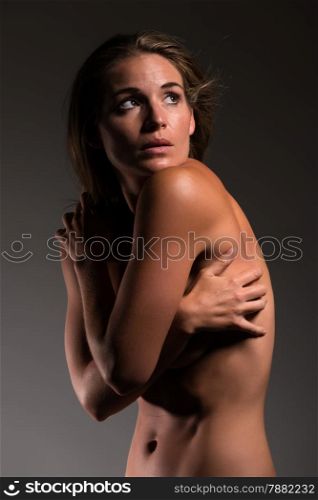 Beautiful sunburned brunette nude in deep shadow