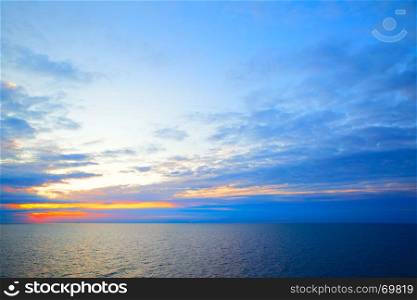 Beautiful sundown in Sweden flag colors - seascape with sea horizon, may be used as background.