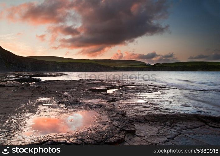 Beautiful sunrise landscape image at Kimmeridge Bay on Jurassic Coast, Dorset, England