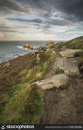 Beautiful sunrise landscape image of Land&rsquo;s End in Cornwall England