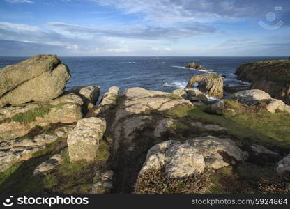 Beautiful sunrise landscape image of Land&rsquo;s End in Cornwall England