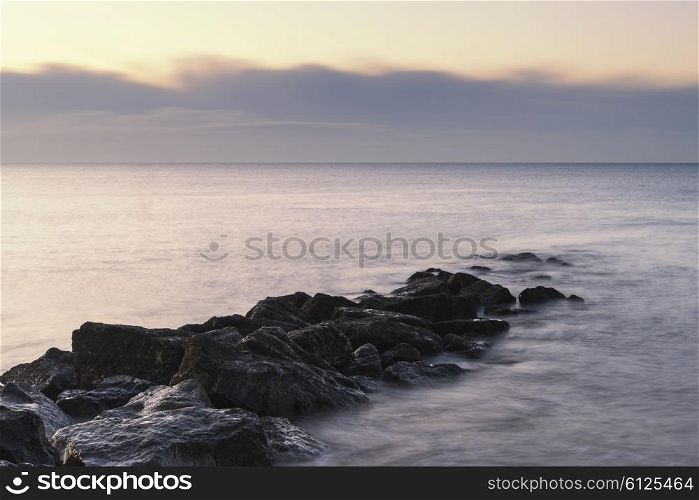 Beautiful sunrise landscape over rocks in sea