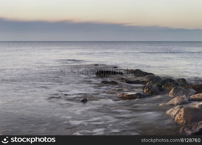 Beautiful sunrise landscape over rocks in sea