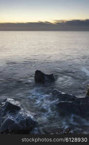 Beautiful sunrise landscape over rocks in sea