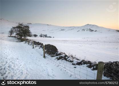 Beautiful sunrise landscape over snow covered Winter countryside