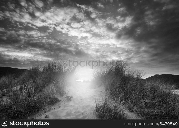 Beautiful sunrise landscape over Three Cliffs Bay on the Gower P. Landscapes. Black and white sunrise landscape over Three Cliffs Bay on the Gower Peninsula in Wales