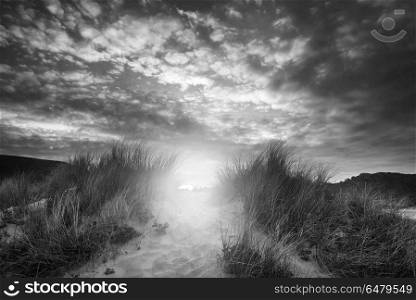 Beautiful sunrise landscape over Three Cliffs Bay on the Gower P. Landscapes. Black and white sunrise landscape over Three Cliffs Bay on the Gower Peninsula in Wales