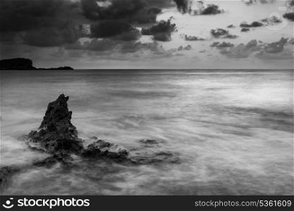 Beautiful sunrise landscape seascape over rocky coastline in Mediterranean Sea in black and white