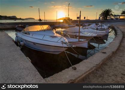 Beautiful sunrise landscape seascape with boats in harbour in Mediterranean Sea
