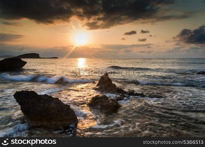 Beautiful sunrise on rocky Mediterranean coastline landscape