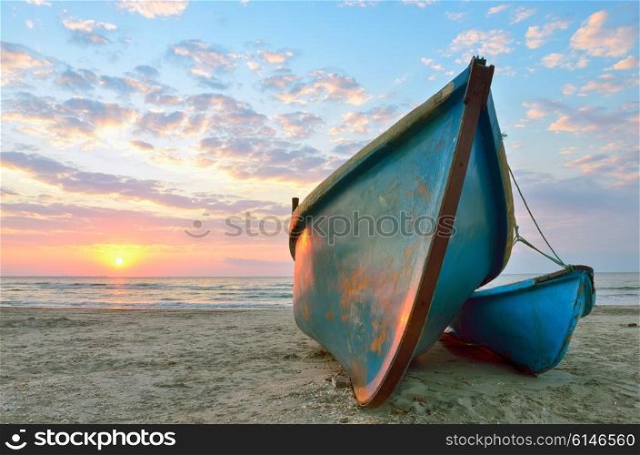 Beautiful sunrise over an two wooden fishing boats