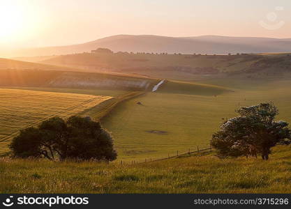 Beautiful sunrise over English countryside landscape in Summer