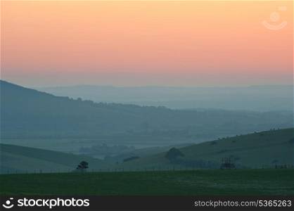 Beautiful sunrise over English countryside landscape in Summer