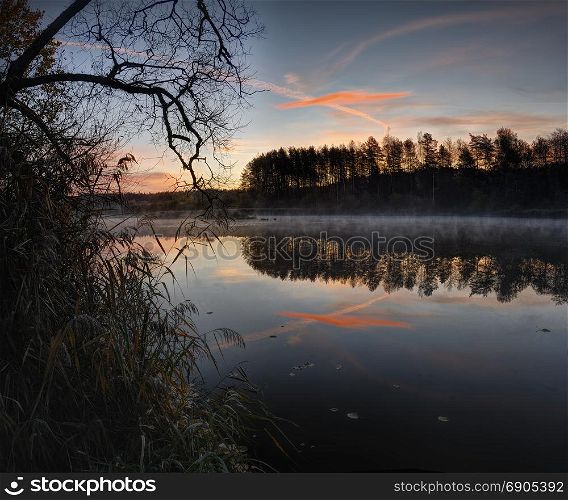 Beautiful sunrise over quiet lake. October morning near Vilnius, Lithuania