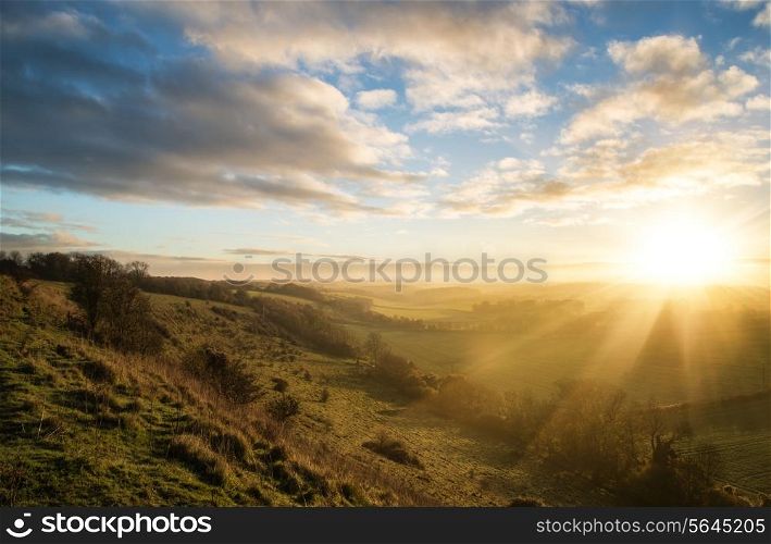 Beautiful sunrise over rolling countryside landscape in Autumn