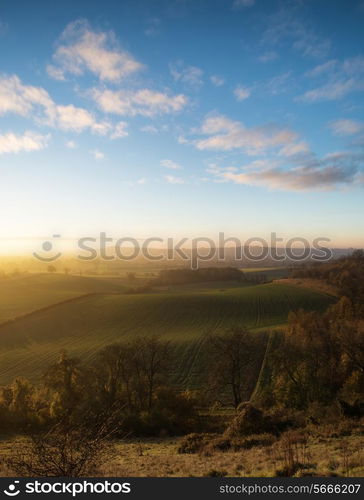 Beautiful sunrise over rolling countryside landscape in Autumn