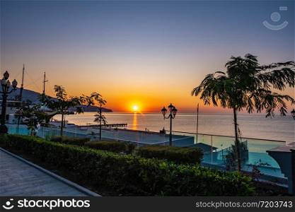 Beautiful sunrise over the calm Black Sea in Yalta, Crimea.