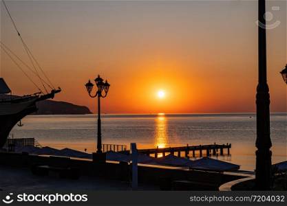 Beautiful sunrise over the calm Black Sea in Yalta, Crimea.