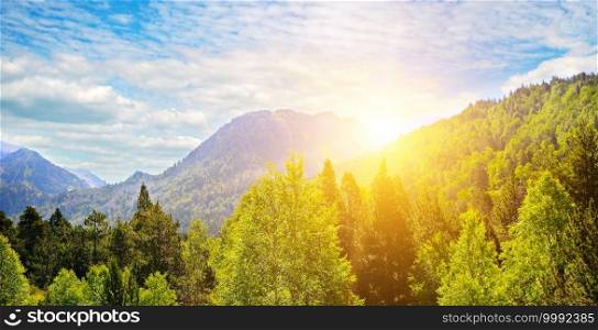 Beautiful sunrise over the mountain range. The concept is travel. Wide photo.