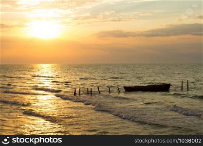 Beautiful sunrise over the sea and fishing boat