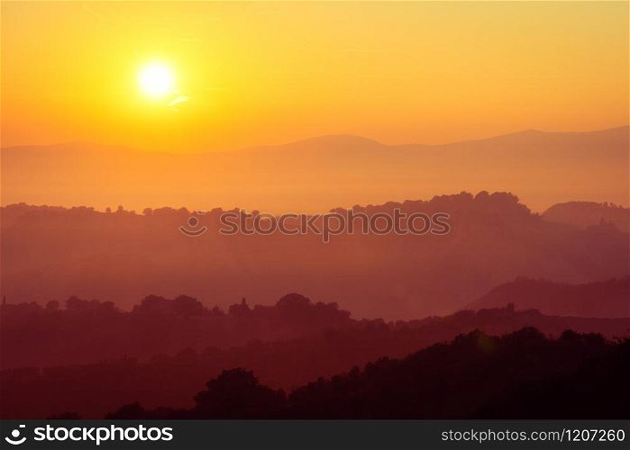 Beautiful sunrise overlooking mountain landscape in the summer morning.. Beautiful sunrise at mountain landscape in summer.