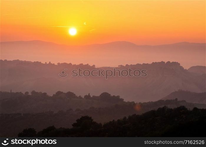 Beautiful sunrise overlooking mountain landscape in the summer morning.. Beautiful sunrise at mountain landscape in summer.