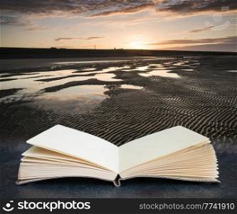 Beautiful sunrise reflected in low tide water pools on beach landscape coming out of pages in book composite image