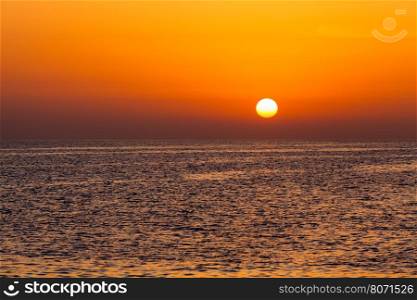 beautiful sunset above the sea. Colorful sunset over water surface
