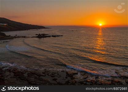Beautiful sunset at a rocky beach in Pomos village, Paphos area, island of Cyprus